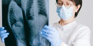 A doctor holding a patient's hand, representing human connection and empathy in 2026.