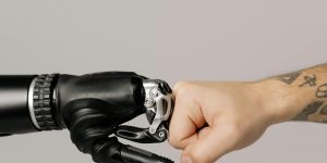 A human hand and a robotic hand reaching out to touch each other, symbolizing the connection between human and machine.