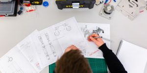 A close-up of disassembled humanoid robot components and wires