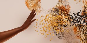 A human hand reaching through golden digital particles