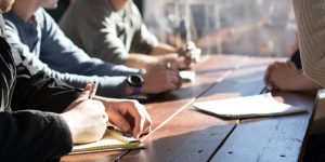A high-tech corporate boardroom representing human-in-the-loop decision making
