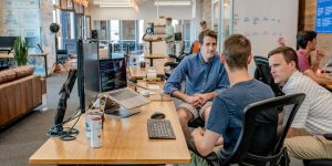 A team of professionals in a high-stakes negotiation in a modern office.