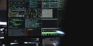 A professional working at a high-tech command center with multiple screens, representing crisis intervention and human-AI collaboration.